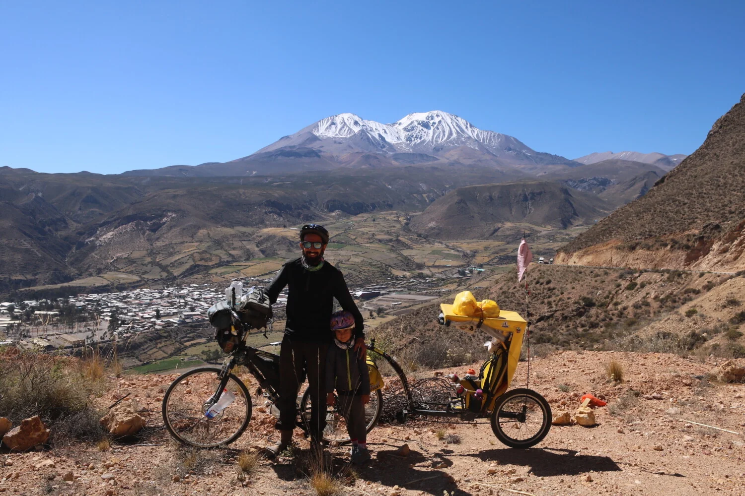 3500 м.н.в на фона на град Путре и вулкан Таапака. Чили